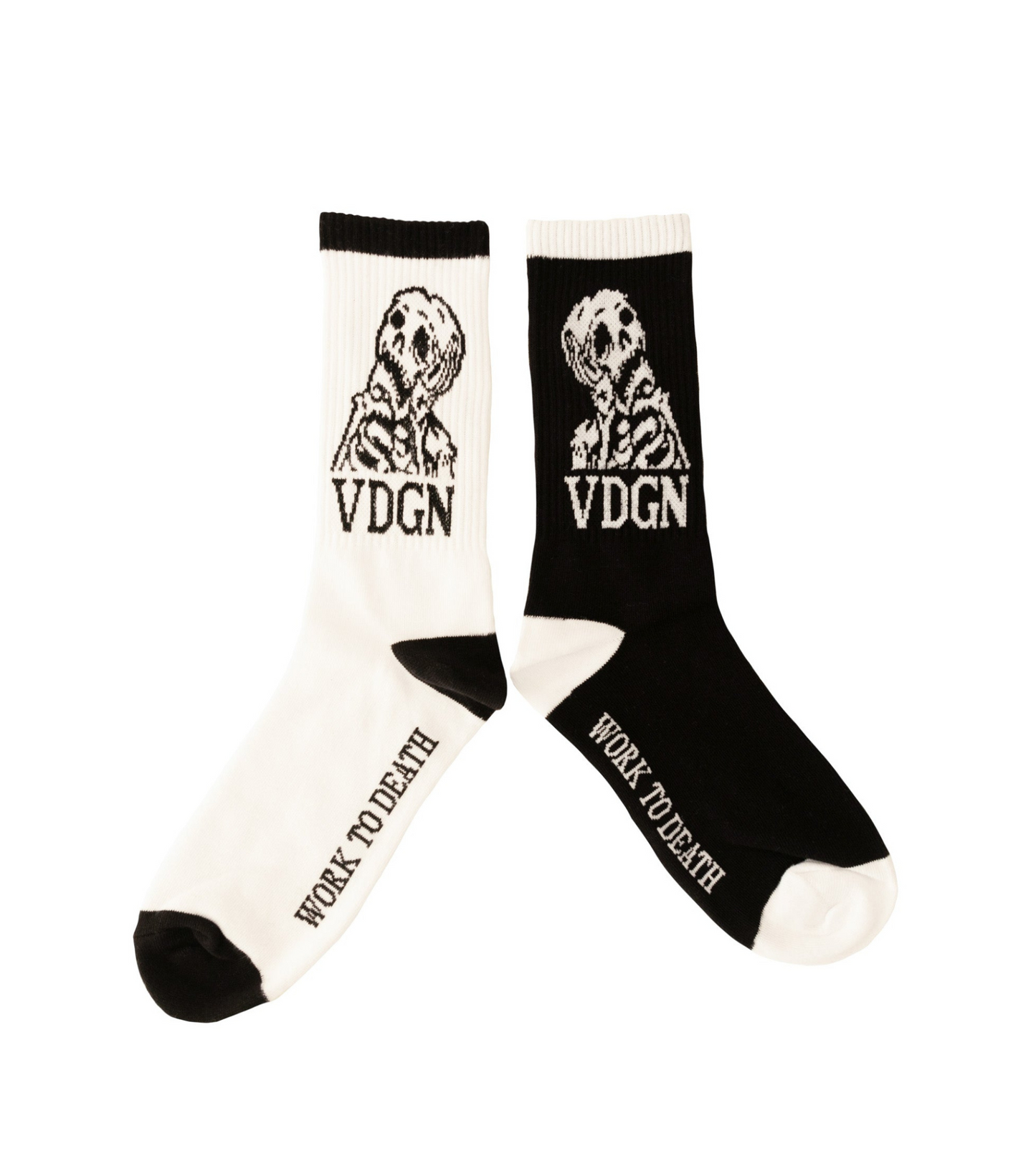 A black and white pair of socks that say work to death on the bottom of the foot with a bored looking skeleton on the calf with VDGN underneath