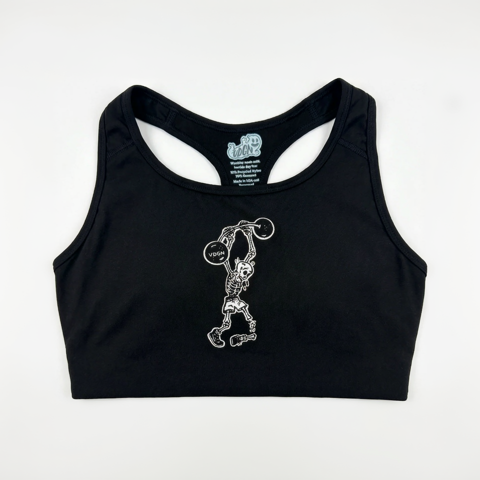 Black sports bra with skeleton lifting weights design on a white background