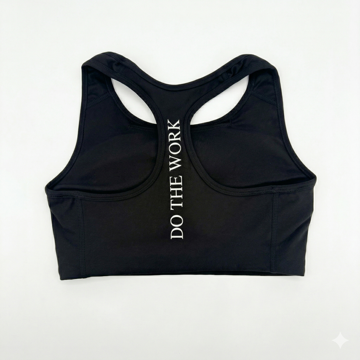 Black sports bra with 'DO THE WORK' text on a white background